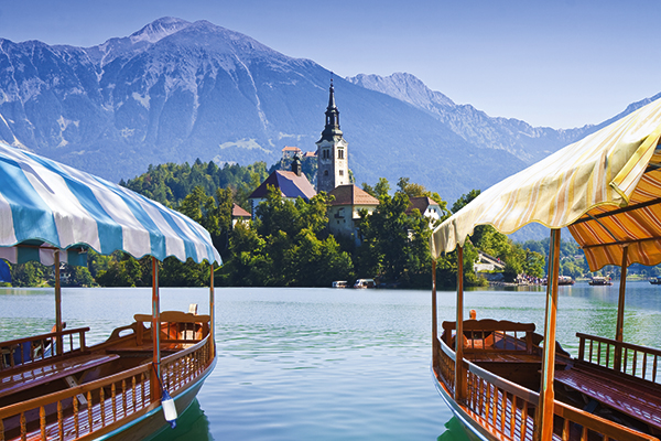 Plenta boats and island church on Lake Bled in Slovenia