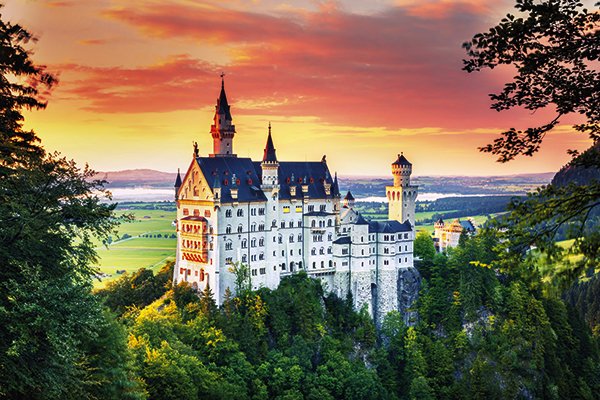 Sunset view of Neuschwanstein Castle in Germany from Mary's Bridge